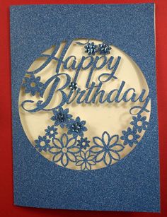 a blue and white birthday card with flowers on it