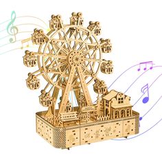 a wooden model of a ferris wheel with musical notes around it and an image of a building