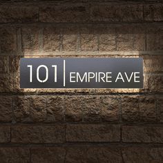 an illuminated sign on a brick wall reads 1011 empire avenue