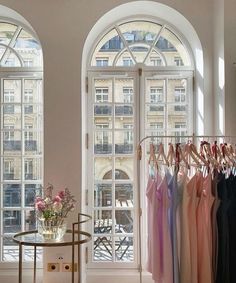 there are many dresses on display in the store, and one is hanging from the rack