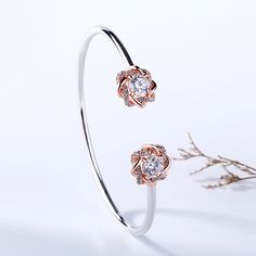 Surround her with flowers all year long. Buy that special someone this silver flower bangle, whether she is celebrating a holiday or if she is just a lover of flowers. Crafted in two tone sterling silver, the bangle consists from two blossoms on the two ends and a high polished bangle, which shows simple elegance. The cuff bangle is easy to adjust the size to fit for her wrist. Surprised her with this charming piece.Carat Weight: 3 ctStone Size: 6 mmNumber of Stones: 2 Stone Shape: RoundStone Co Rose Gold Bangle For Anniversary, Fine Jewelry, Rose Gold Fine Jewelry Bangle For Anniversary, Rose Gold Bangle For Anniversary In Fine Jewelry Style, Rose Gold Bangle For Anniversary In Fine Style, Elegant Rose Gold Sterling Silver Bracelet For Anniversary, Elegant Sterling Silver Flower Bracelet, Elegant Rose Gold Sterling Silver Anniversary Bracelet, Elegant Sterling Silver Bracelet For Anniversary And Mother's Day, Rose Gold Sterling Silver Bangle Bracelet