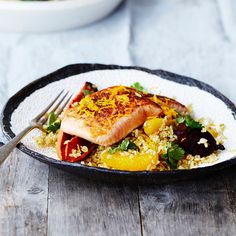 a white plate topped with fish and rice