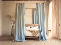 a bed with blue drapes hanging from it's sides