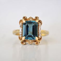 Read about our payment plans before proceeding. Make a lasting impression with the Isis London Blue Topaz Scroll Diamond Ring and its saturated deep blue color. Crafted from 14K gold or 18K solid gold, this stunning piece features a natural london blue topaz centerpiece and delicate baguette diamonds, inspired by the iconic architecture of New York City. All order comes in a Tippy Taste ring box. This ring is handmade and designed in NYC. 14K or 18K solid gold Natural 9*7mm London Blue Topaz Nat Pink Sapphire Diamond Ring, Iconic Architecture, Pear Diamond Rings, Marquise Diamond Ring, Deep Blue Color, Asscher Diamond, Pear Ring, Ruby Diamond Rings, September Wedding