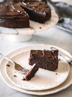 two plates with slices of chocolate cake on them