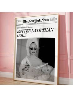 the new york news newspaper is displayed in front of a pink wall with a photo of a woman reading a magazine