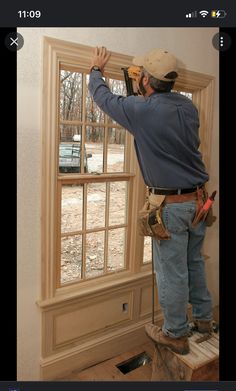 a man is working on a window in the process of remodeling it