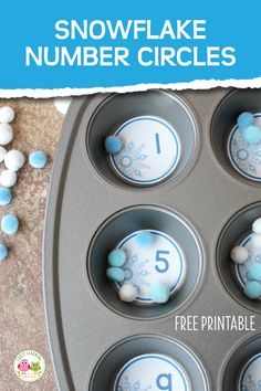 a cupcake pan filled with blue and white snowflake numbers