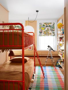 a bedroom with two bunk beds and a colorful rug on the floor in front of it