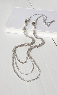 Long layered chains necklace sparkly glass beads and white freshwater pearls Multi-strand Metal Necklace With Pearl Chain, Layering Pearl Necklace With Chain, Multi-strand Metal Pearl Chain Jewelry, Silver Multi-strand Pearl Chain Necklace, White Beaded Necklace With Adjustable Chain, Silver Pearl Chain Layered Necklace, Pearl Necklace With Chain For Layering, Silver Pearl Beaded Necklaces, Silver Multi-strand Layered Necklace With Pearl Chain