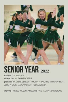 a group of cheerleaders in green and white outfits with their hands up to the air