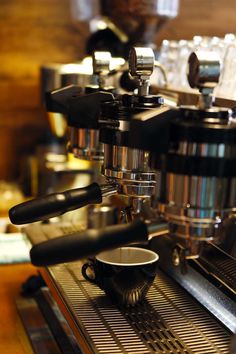 an espresso machine with two cups on it