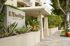 the entrance to an apartment building with landscaping