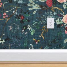 a floral wallpaper with a light switch in the middle and an image of flowers on it