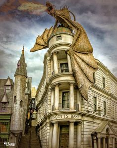 a large building with a dragon statue on top of it's roof and stairs