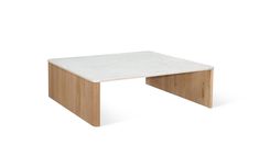 a white marble top coffee table with wooden legs and an angled design on the bottom