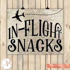 a sign that says in - flight snacks with an airplane flying over the map on it