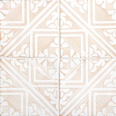 a white tile with an intricate design on it