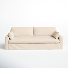 a white couch sitting on top of a white floor