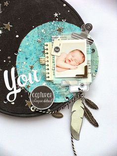 a baby's photo is attached to a black and blue scrapbook with the word you written on it