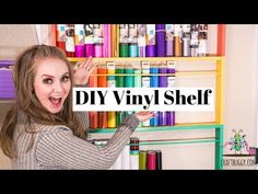 a woman standing in front of a shelf filled with lots of different colored crayons