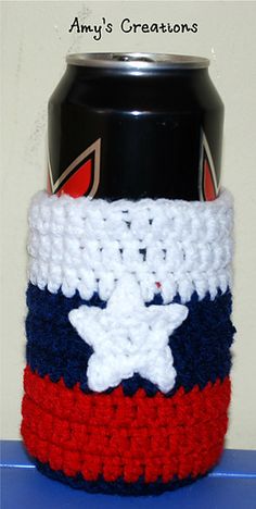 a crocheted can holder with a white star on it