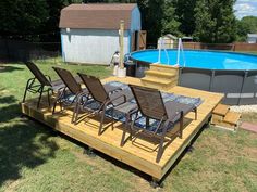 an above ground swimming pool surrounded by lawn chairs and a deck that has been built into it