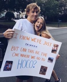 a man and woman holding a sign that says, it know we're just friends but can this be the one where we go to hoo?