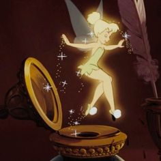 a cartoon tinkerbell flying over a mirror with a feather in it's hand