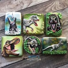 four dinosaur coasters are sitting on a wooden table with the same design as each one