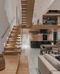 a living room filled with furniture and stairs