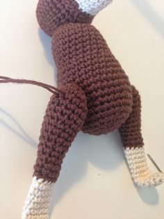 a crocheted stuffed animal is laying down