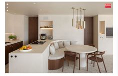 a kitchen with a table and chairs next to a counter top in front of a sink