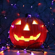 a lighted jack o lantern sitting on top of a table