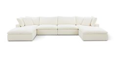 a white sectional couch with pillows on it's back and the seat folded out