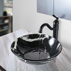 a black and white bowl sink sitting on top of a counter next to a faucet