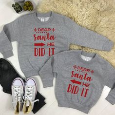 two sweatshirts with the words dear santa and did it printed on them next to sneakers