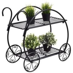 a black metal cart with plants on it