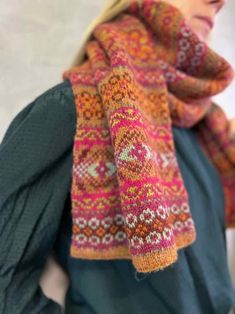 a woman wearing a colorful scarf and hat