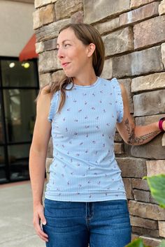 Sweet and feminine floral sleeveless top with flutter ruffled detail on the sleeve armholes. Made with soft and stretchy fabric in a light blue color. 95% Polyester / 5% Spandex Fit Notes: This top runs small. We recommend sizing up one. ----------- NOTE: All items with prices ending in .19 are considered closeout/clearance items that we will not be restocking. Last chance -- get it for a steal! (No returns or exchanges on .19 priced FINAL SALE items.) Light Blue Ruffle Sleeve Top For Spring, Blue Floral Print Tops With Ruffle Sleeves, Sleeveless Light Blue Floral Print Top, Casual Light Blue Sleeveless Blouse, Stretch Tank Top With Ruffles, Feminine Blue Top With Flutter Sleeves, Light Blue Casual Tops With Ruffle Sleeves, Feminine Blue Flutter Sleeve Top, Casual Light Blue Tops With Ruffle Sleeves