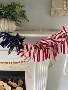 an american flag garland is hanging on the mantle