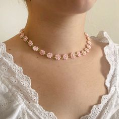 "Handmade baby pink beaded daisy/flower necklace. Beads are glass and hardware is 14kt gold-filled. Necklace length is approximately 13.5\" (34 cm)  and with hardware, approximately 14.5\" (37 cm). Intended fit for necklace is at base of neck, not choker-length." Pink Tiny Beads Jewelry For Spring, Pink Round Beads Necklace For Spring, Spring Pink Beaded Necklace, Handmade Pink Dainty Beaded Necklaces, Handmade Pink Dainty Beaded Necklace, Handmade Dainty Pink Beaded Necklace, Dainty Handmade Pink Beaded Necklaces, Spring Pink Round Bead Necklaces, Dainty Handmade Pink Beaded Necklace