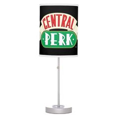 a lamp with a sign that says central perk on the front and back of it