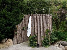 a towel hanging on a wooden fence next to trees