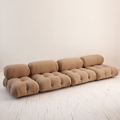 a long couch sitting on top of a white floor