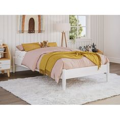 a white bed with yellow blankets and pillows