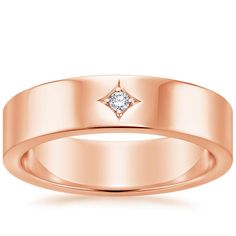 a rose gold wedding ring with a diamond