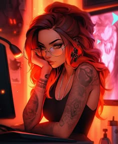 a woman with red hair and tattoos sitting at a desk in front of a computer