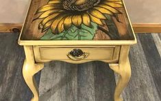 a small table with a painted sunflower on it