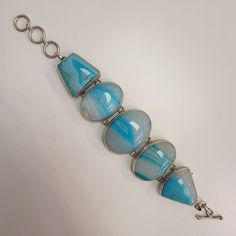 An estate sterling silver bracelet with multi shaped dyed blue agate natural gemstones bezel set. The bracelet is 7" adjustable to 8" in length and 1.5" wide. Agate Bracelet, Blue Agate, Sterling Silver Bracelet, Silver Blue, Bezel Setting, Silver Bracelets, Sterling Silver Bracelets, Turquoise Bracelet, Natural Gemstones